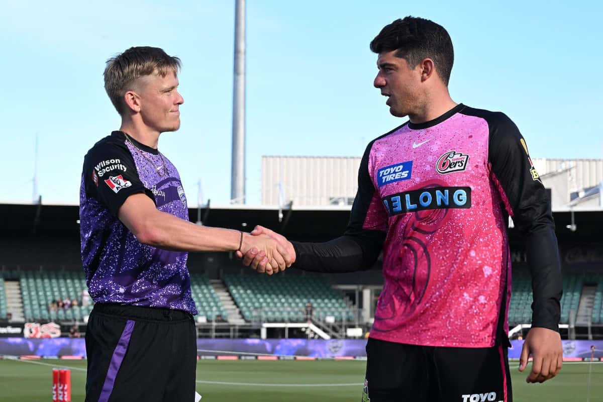 Nathan Ellis Captain of Hobart Hurricanes and Moses Henriques Captain of Sydney Sixers shake hands ahead of the BBL match