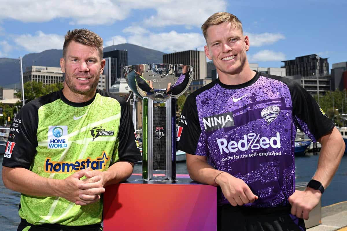 Nathan Ellis of the Hobart Hurricanes and David Warner of the Sydney Thunder pose with Trophy ahead of BBL 2024-25 Final